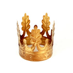 Ornate antiqued gold Santos crown featuring decorative laurel leaves and vintage-style distressed finish