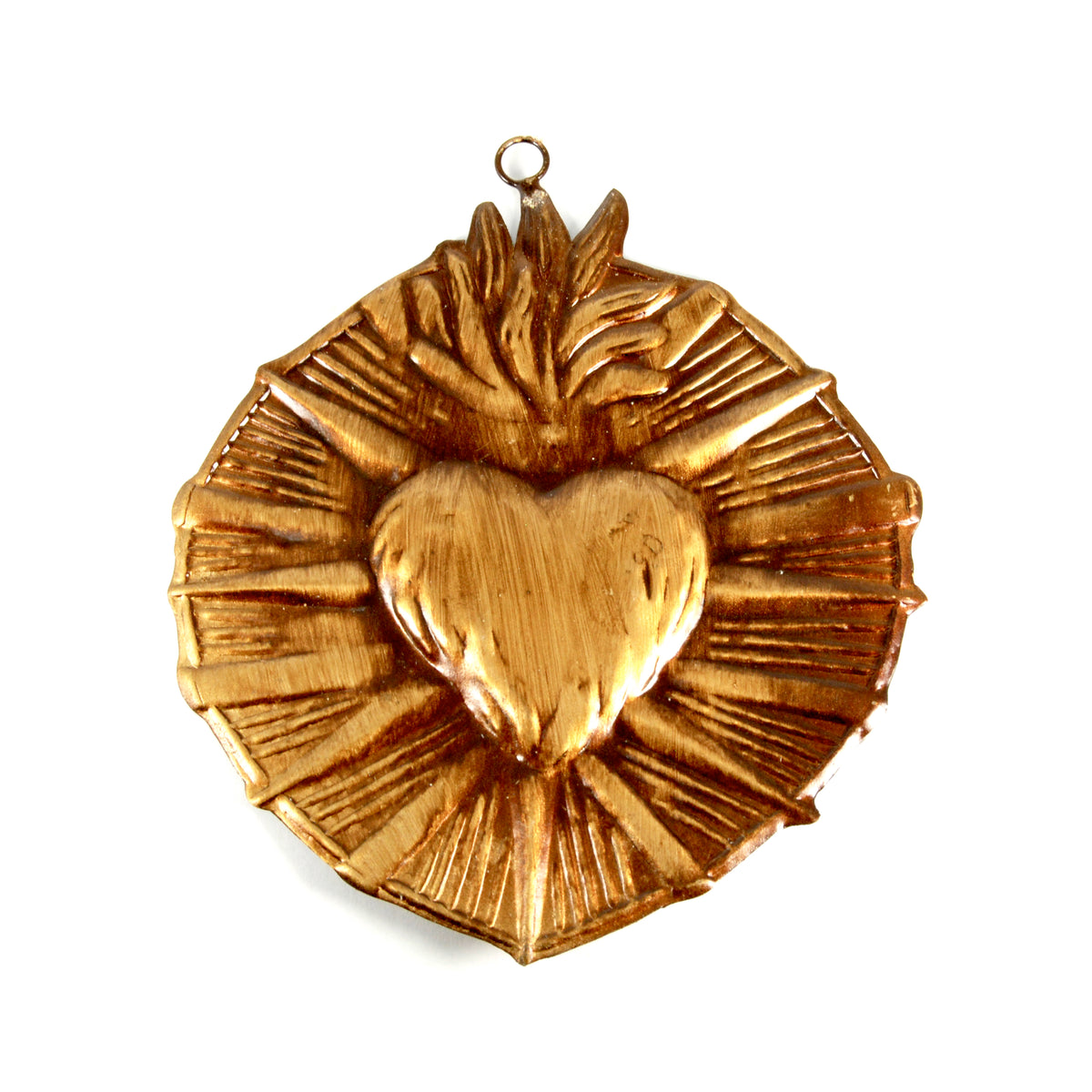 Ornate gold-toned Sacred Heart milagro featuring embossed flaming heart surrounded by decorative starburst rays