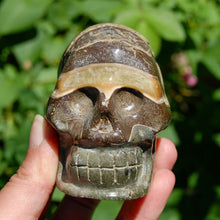 Load image into Gallery viewer, Red Ammonite Hand Carved Crystal Skull
