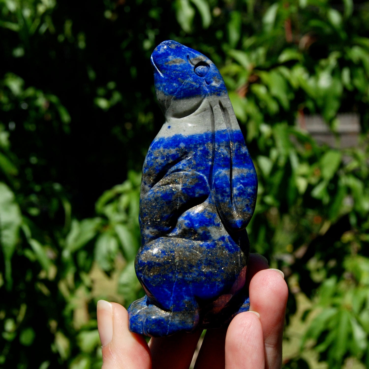 Hand-carved Lapis Lazuli crystal rabbit figurine with deep blue gemstone and golden pyrite flecks