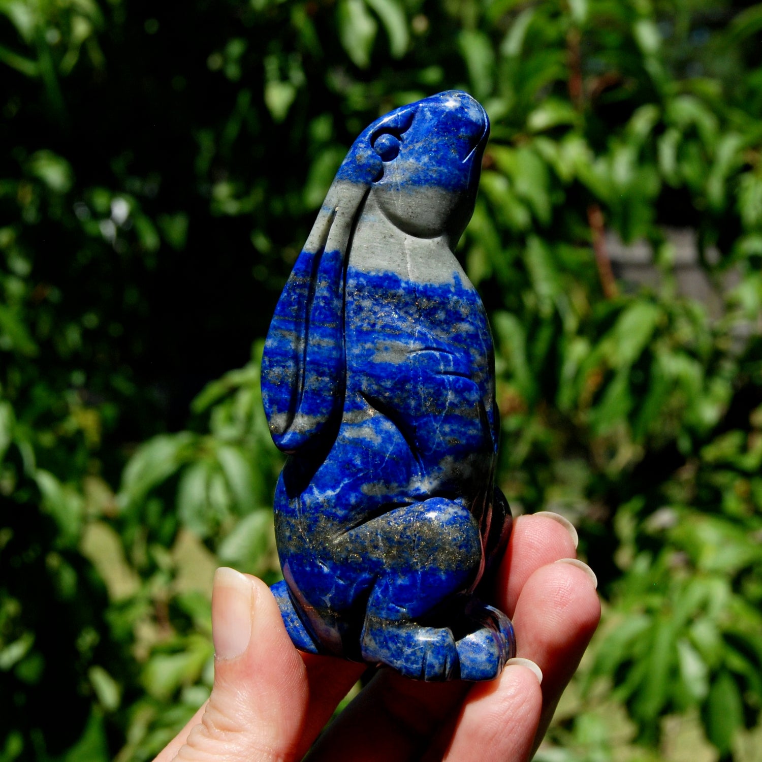 Hand-carved Lapis Lazuli crystal rabbit figurine with deep blue gemstone and golden pyrite flecks